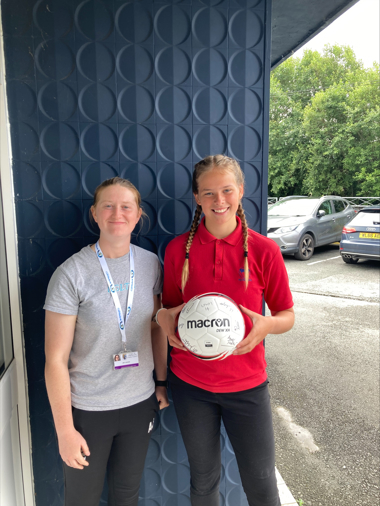 Amy Jenkins, Youth Worker with Ceredigion County Council presenting an award to the winner of the competition, Katie Whiteway.